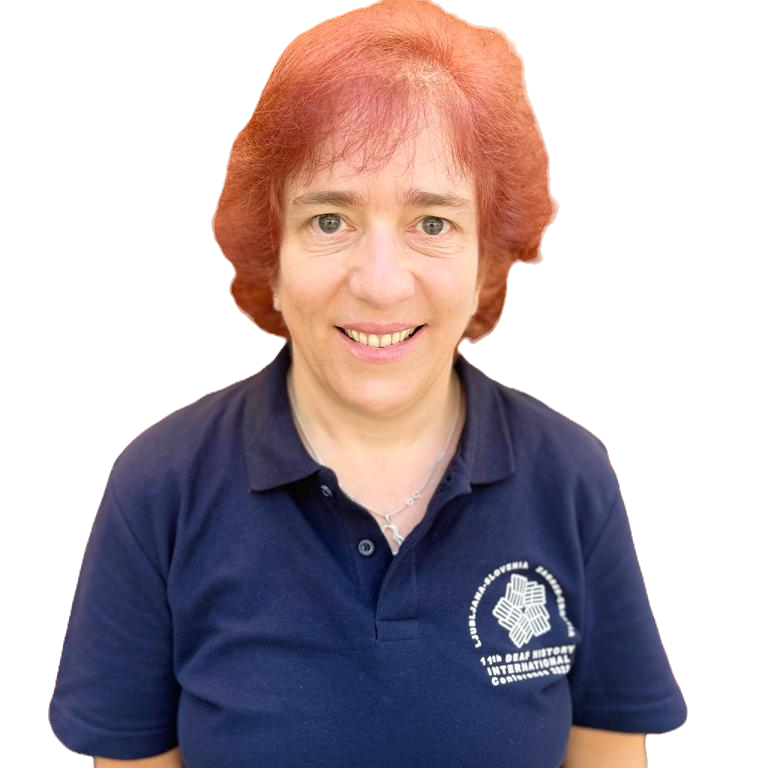 A white woman with red hair, wearing a DHI polo shirt.